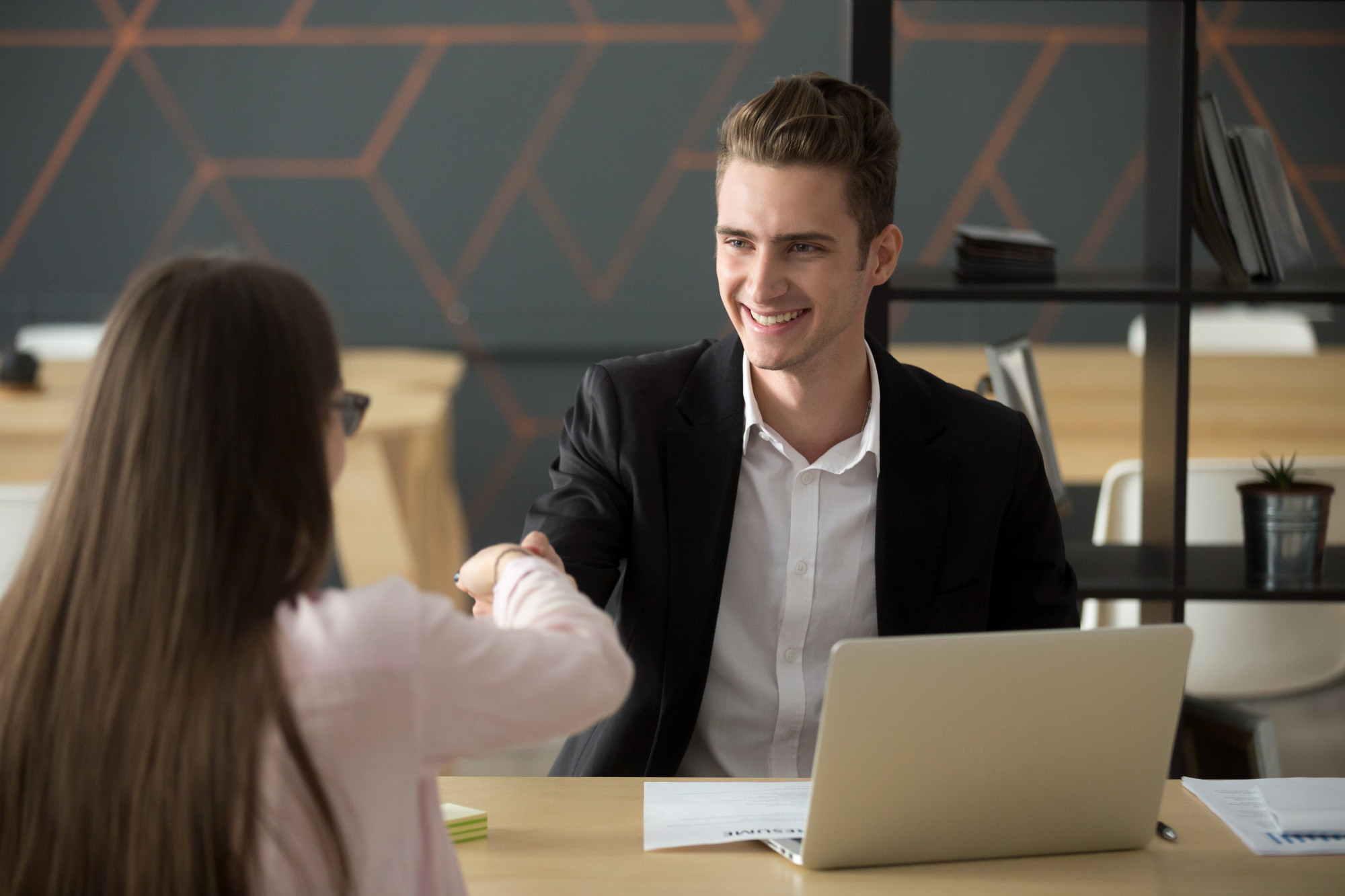 smiling-hr-employer-handshaking-successful-job-applicant-hiring-or-greeting